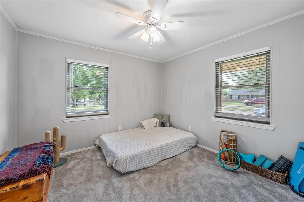 621 Athens Street Canton, TX 75103 - Photo 14 of 25 a bedroom with a bed and a chandelier