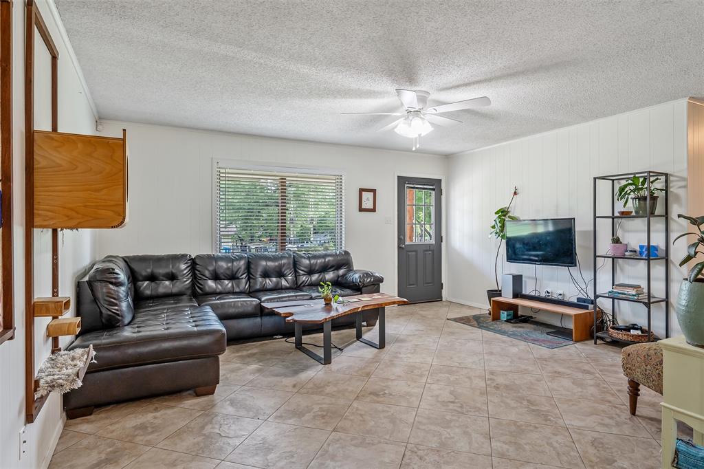 621 Athens Street Canton, TX 75103 - Photo 2 of 25 a living room with furniture and a flat screen tv