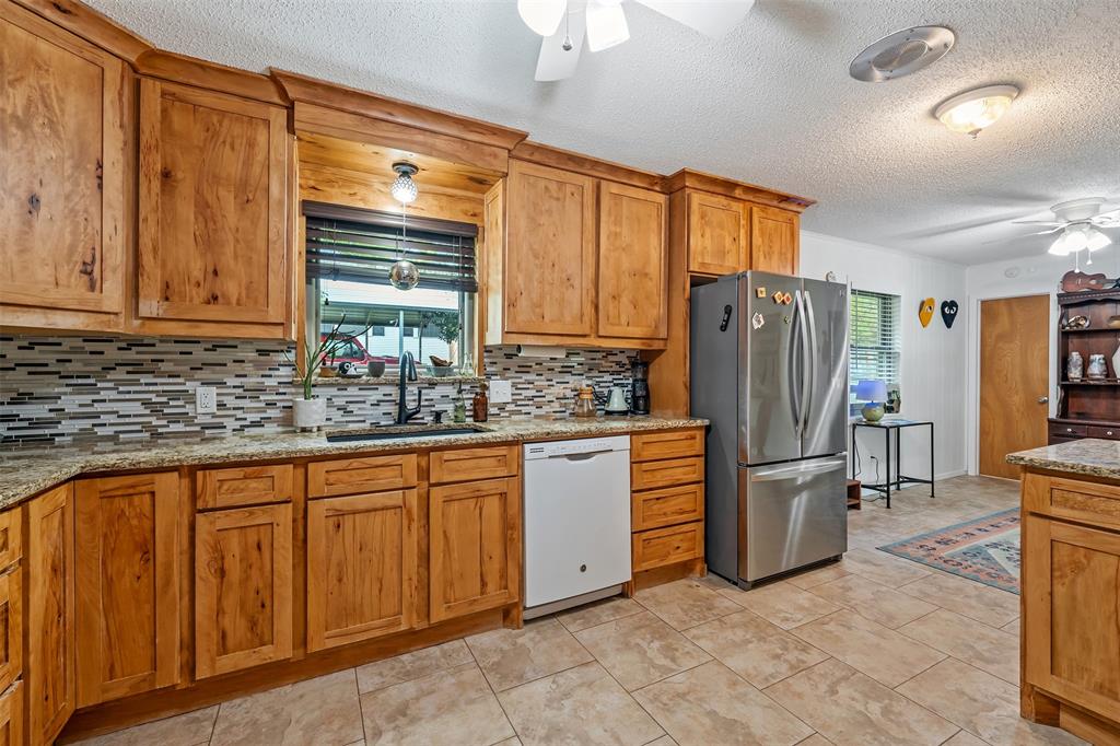 621 Athens Street Canton, TX 75103 - Photo 5 of 25 a kitchen with refrigerator and cabinets