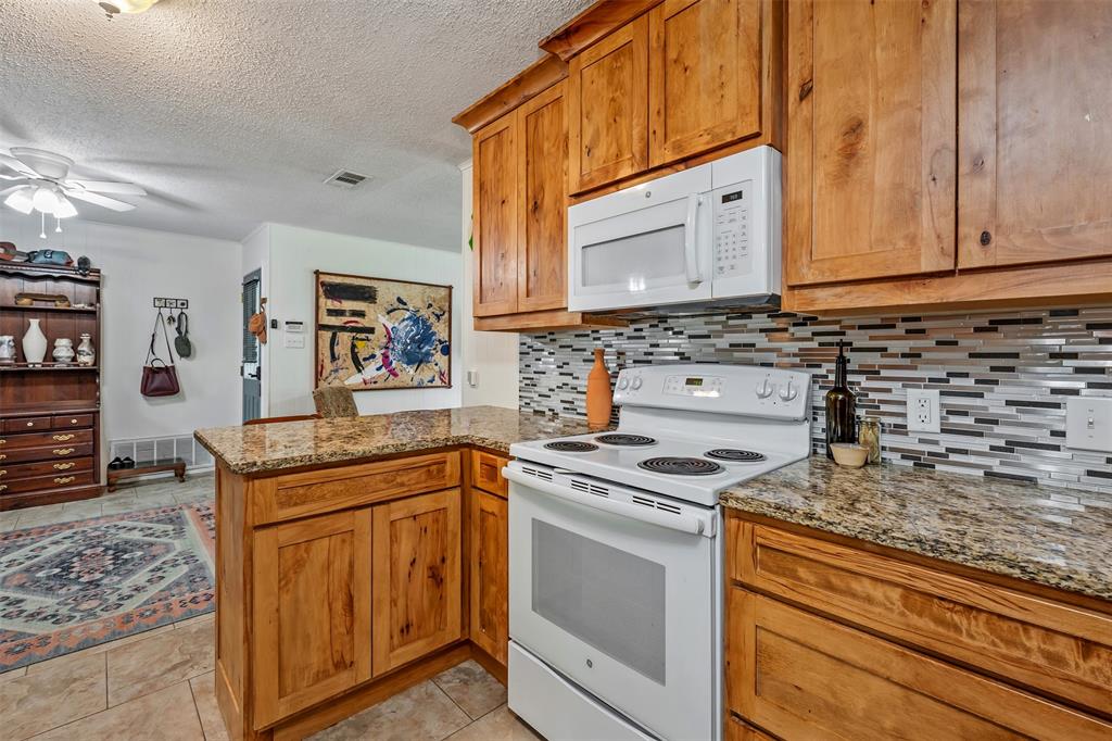 621 Athens Street Canton, TX 75103 - Photo 7 of 25 a kitchen with stainless steel appliances granite countertop a stove sink and cabinets
