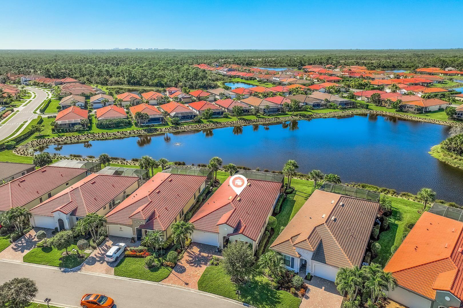 an aerial view of residential houses with outdoor space and swimming pool