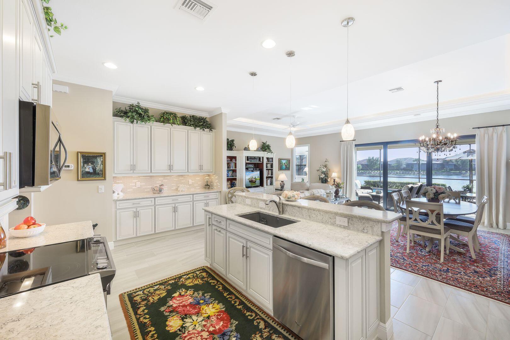 1433 Redona Way Naples, FL 34113 - Photo 12 of 50 a kitchen with a sink stove and cabinets