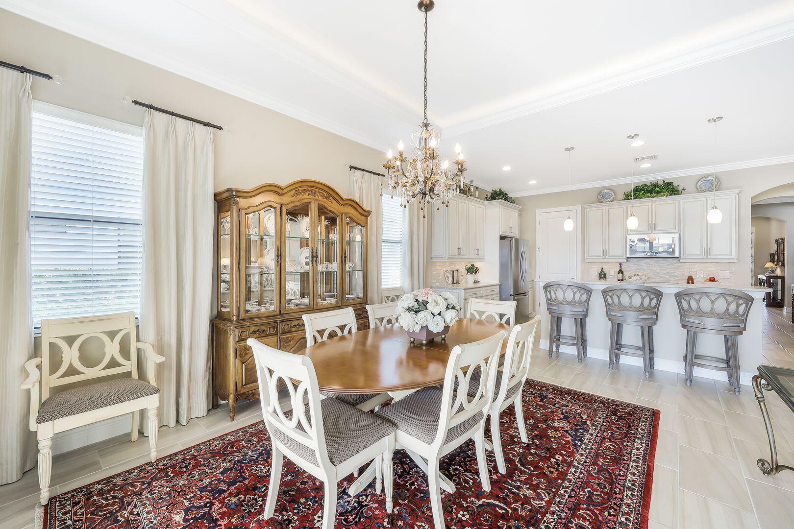 1433 Redona Way Naples, FL 34113 - Photo 13 of 50 a view of a dining room with furniture window and wooden floor