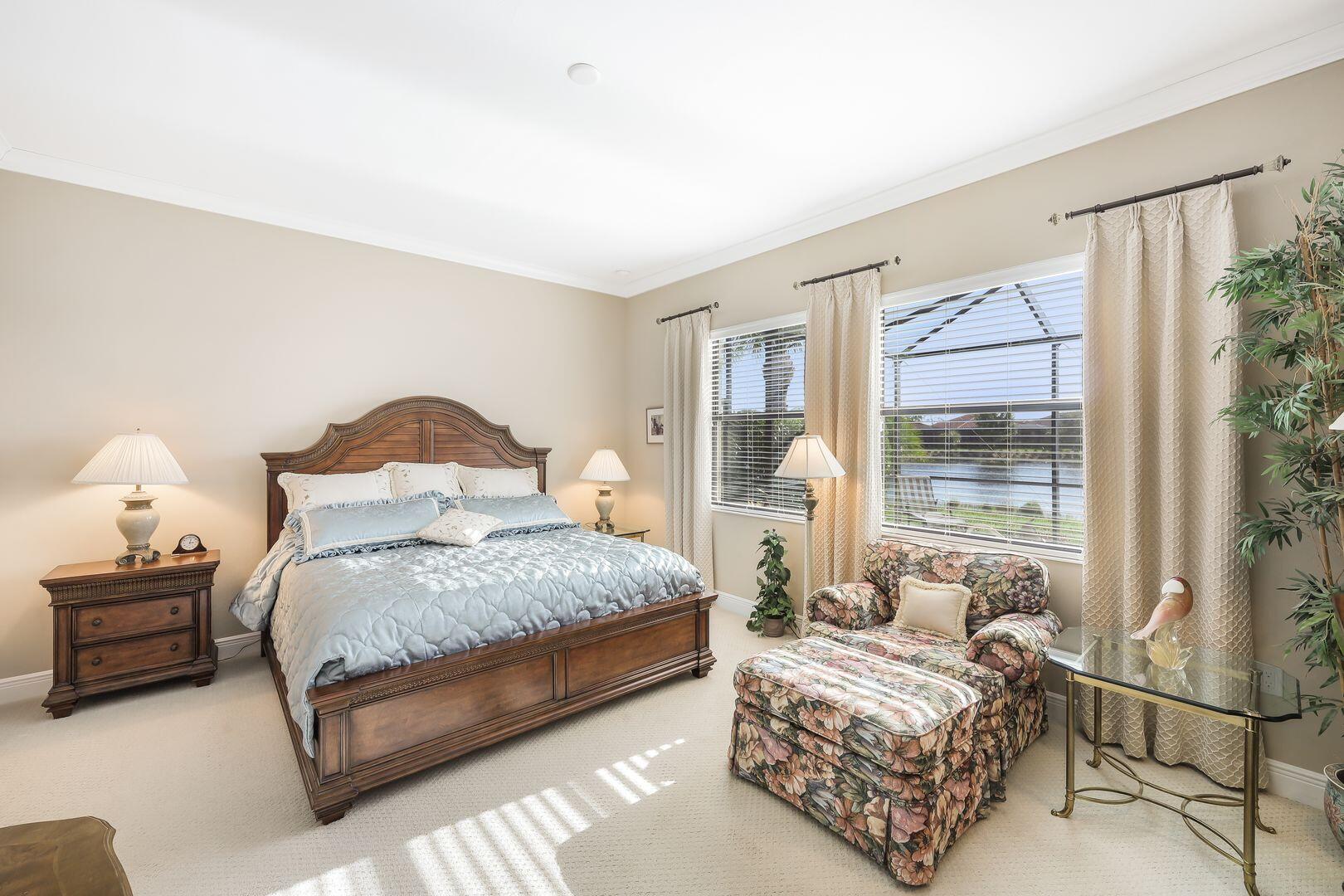 1433 Redona Way Naples, FL 34113 - Photo 14 of 50 a spacious bedroom with a bed and a window