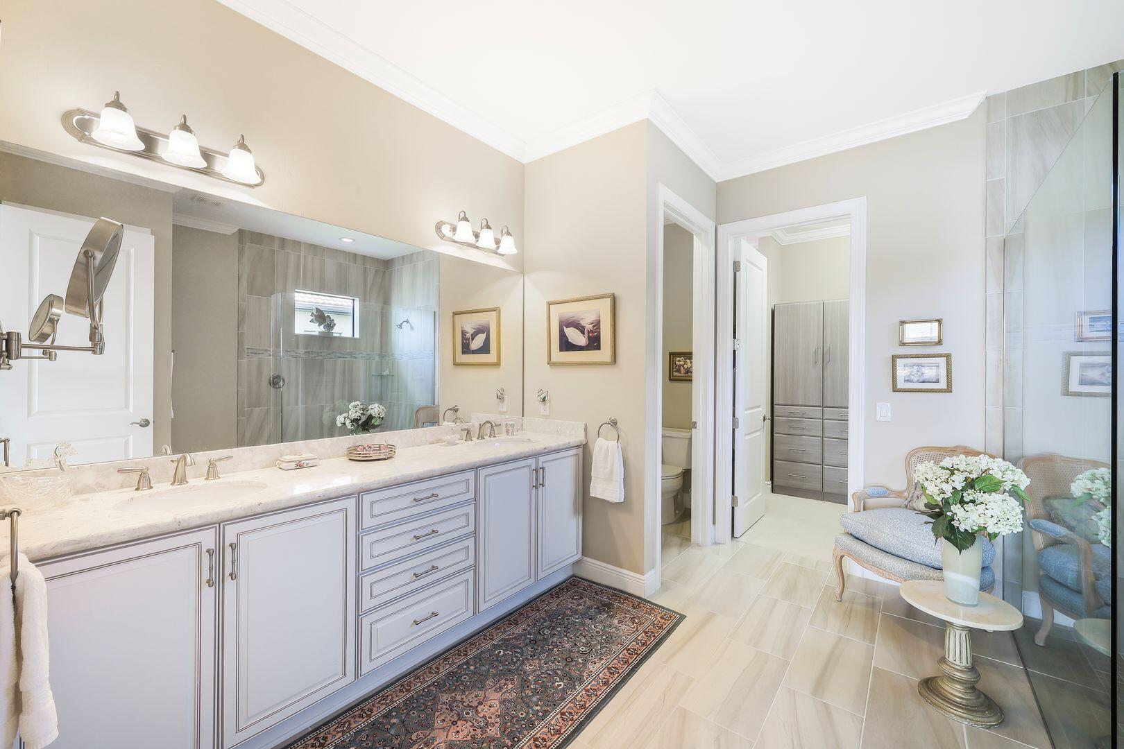 1433 Redona Way Naples, FL 34113 - Photo 16 of 50 a spacious bathroom with a double vanity sink a mirror and a shower