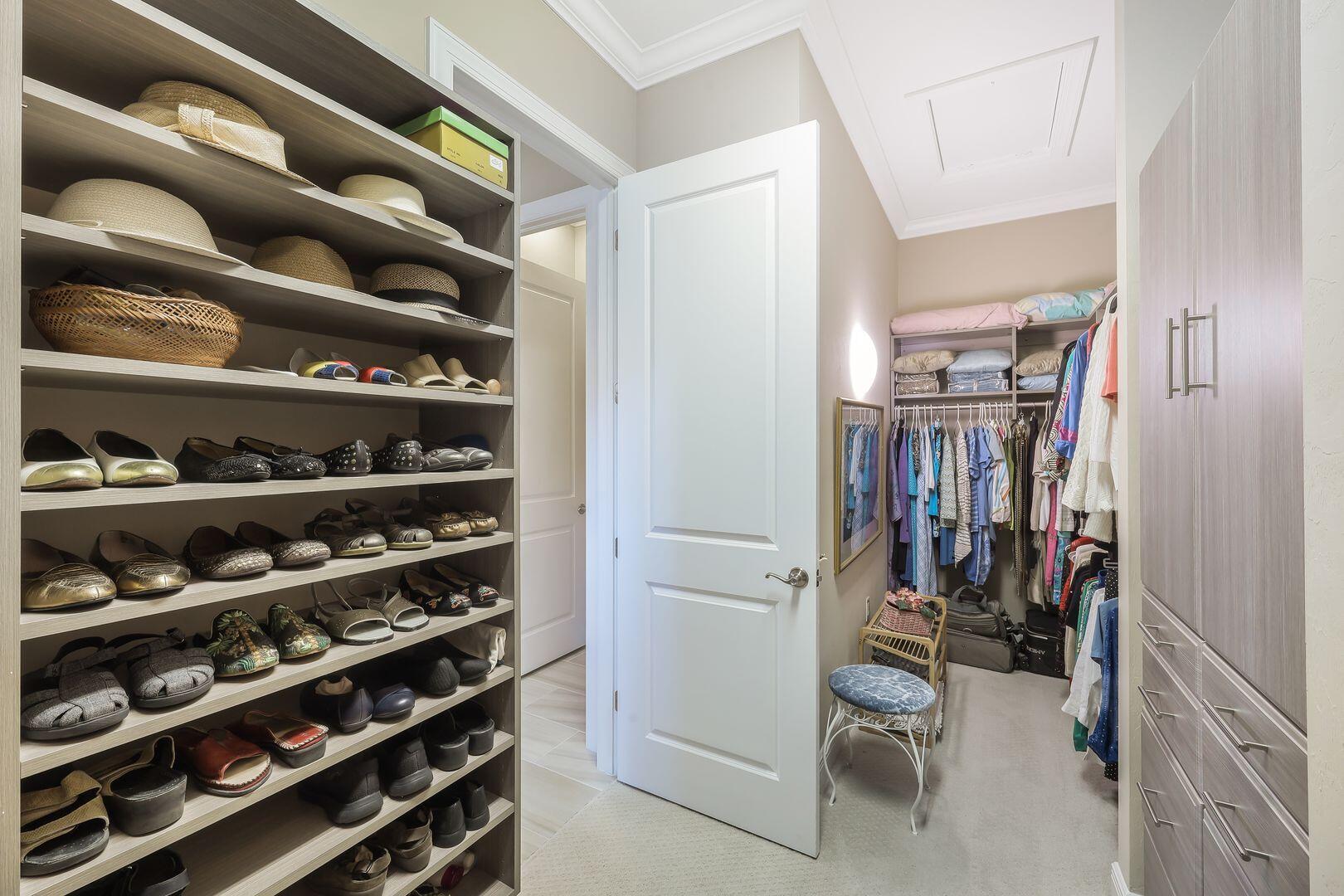 1433 Redona Way Naples, FL 34113 - Photo 19 of 50 a view of walk in closet with clothes and shoes