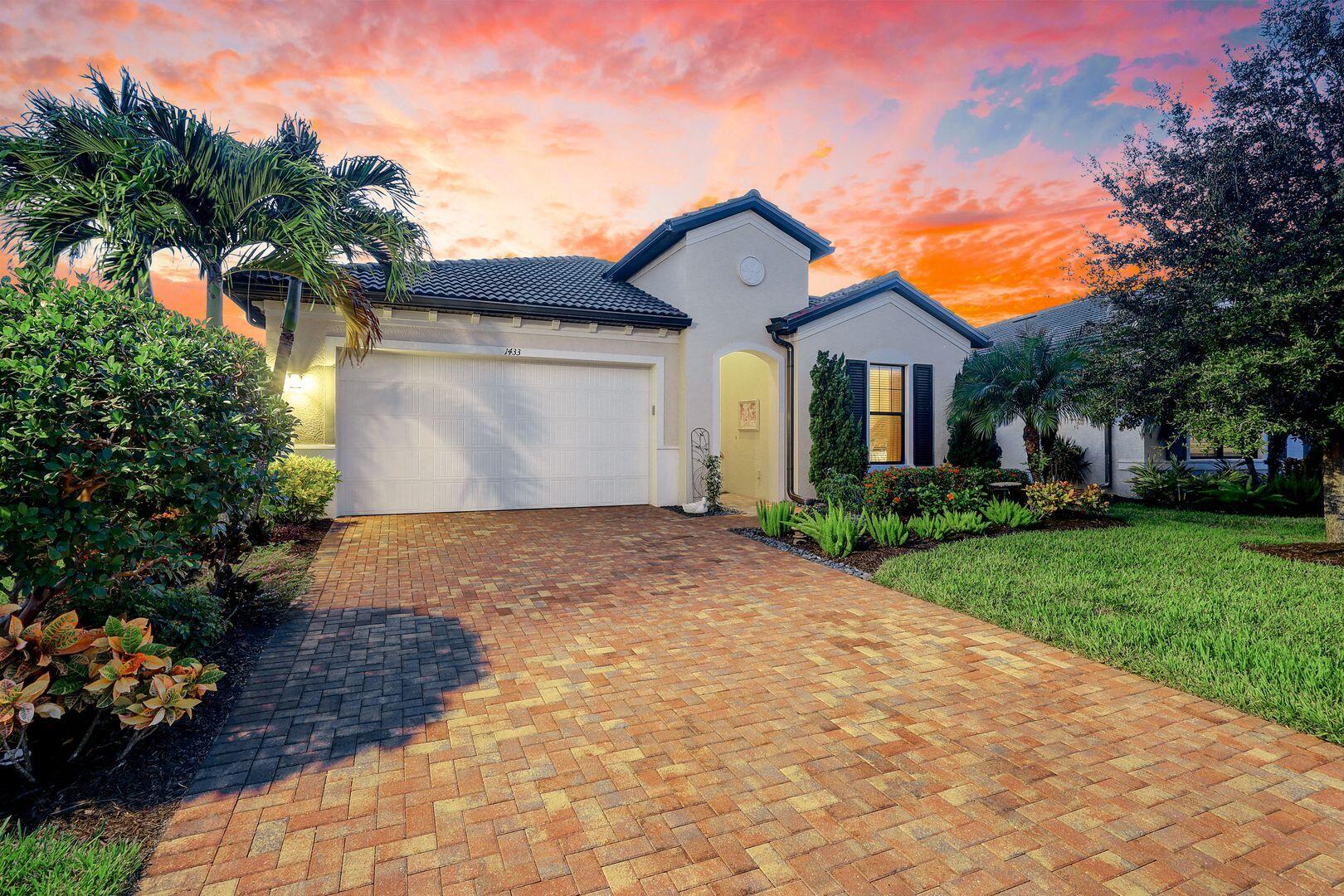 1433 Redona Way Naples, FL 34113 - Photo 2 of 50 a front view of a house with a yard and a garage