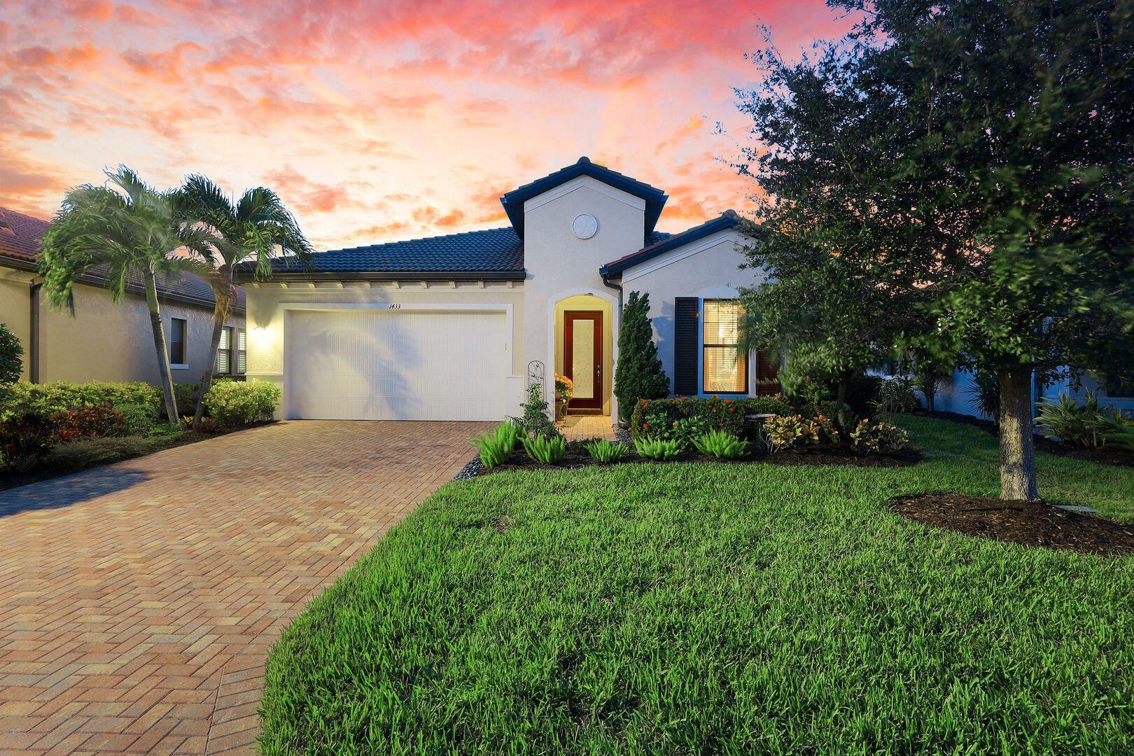 1433 Redona Way Naples, FL 34113 - Photo 21 of 50 a front view of a house with a yard and garage