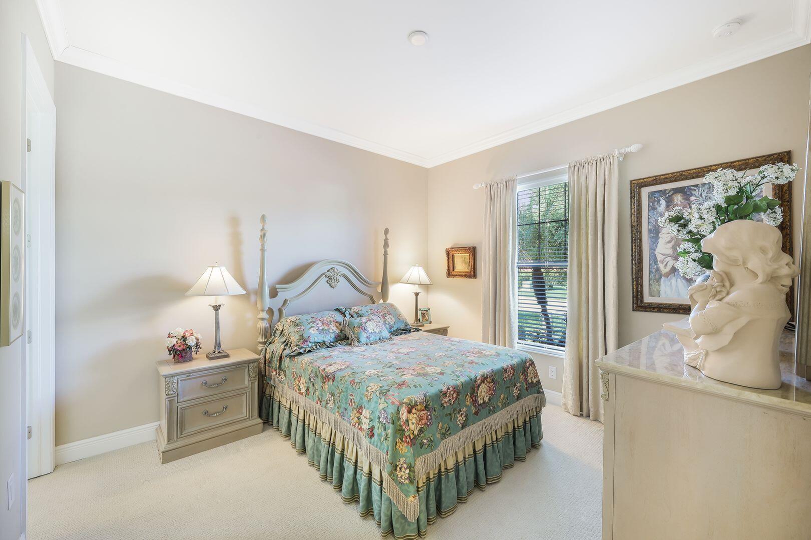 1433 Redona Way Naples, FL 34113 - Photo 22 of 50 a bedroom with a bed a large window and dresser