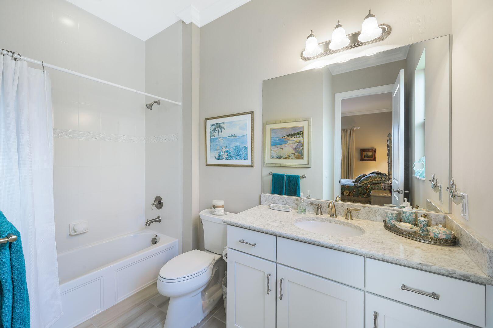 1433 Redona Way Naples, FL 34113 - Photo 23 of 50 a bathroom with a granite countertop sink toilet and shower