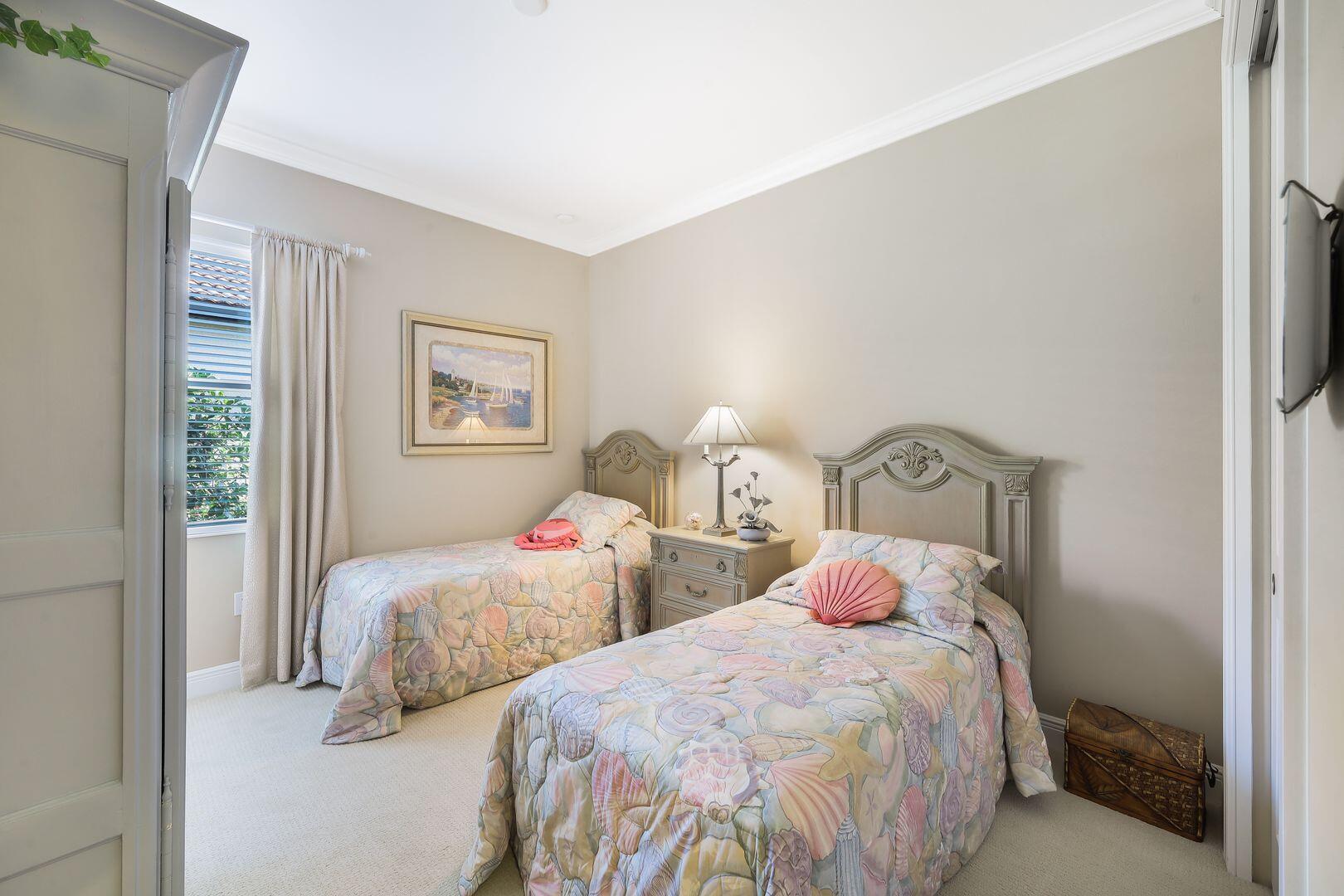 1433 Redona Way Naples, FL 34113 - Photo 24 of 50 a bedroom with two beds and a night stand