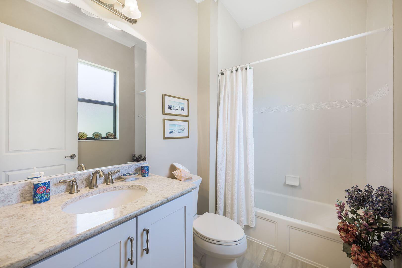 1433 Redona Way Naples, FL 34113 - Photo 25 of 50 a bathroom with a granite countertop sink a toilet and shower