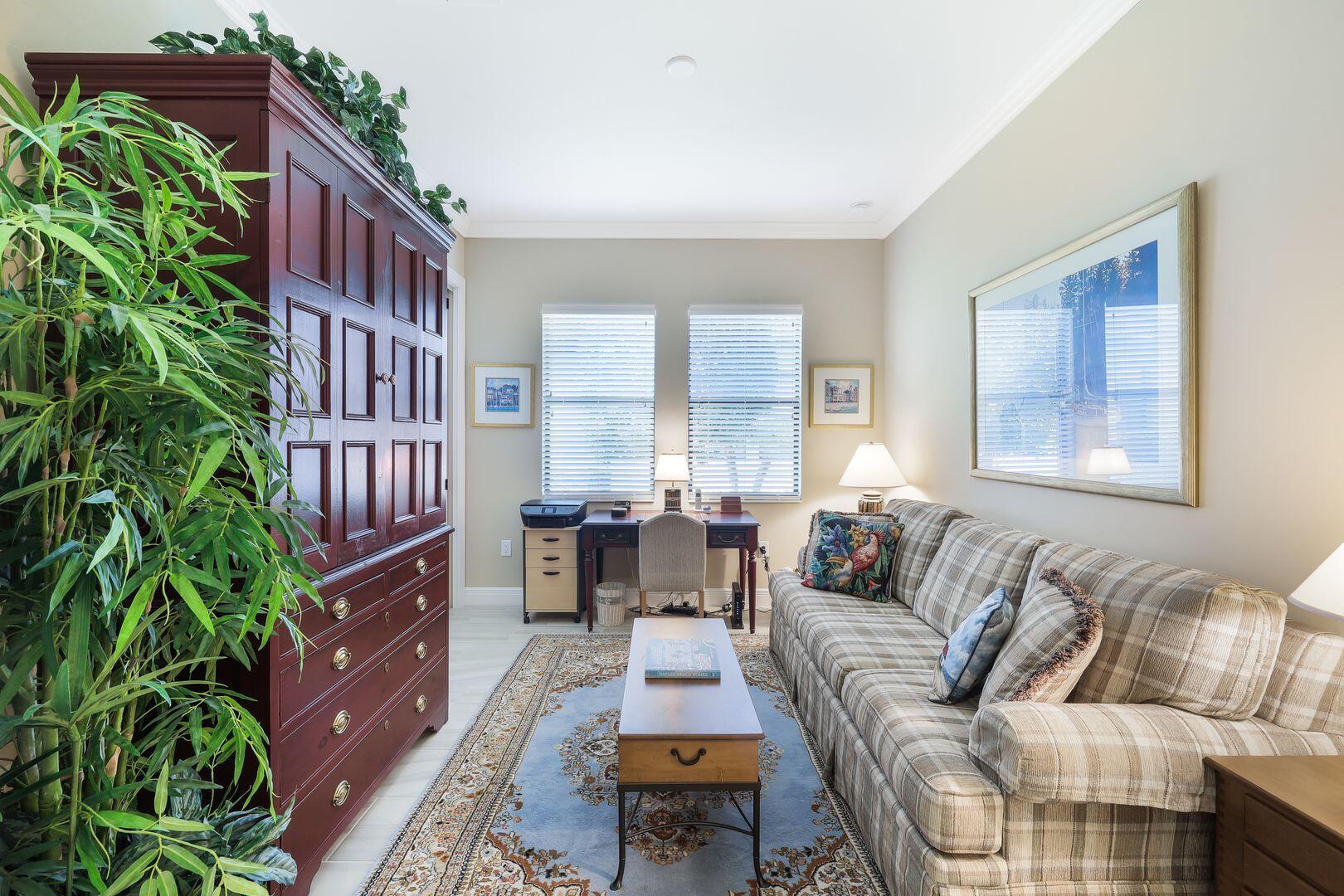 1433 Redona Way Naples, FL 34113 - Photo 26 of 50 a living room with furniture and a potted plant