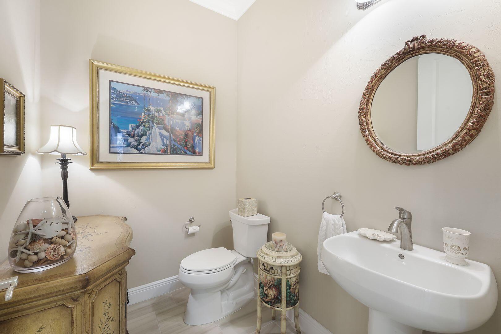 1433 Redona Way Naples, FL 34113 - Photo 27 of 50 a bathroom with a toilet a sink and a mirror