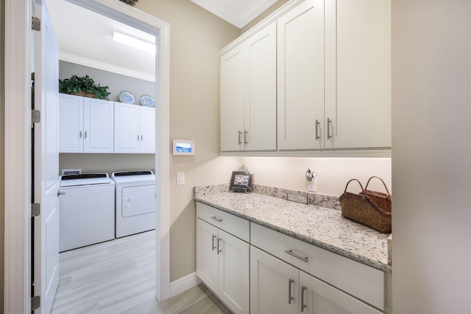 1433 Redona Way Naples, FL 34113 - Photo 29 of 50 a kitchen with granite countertop white cabinets and white appliances