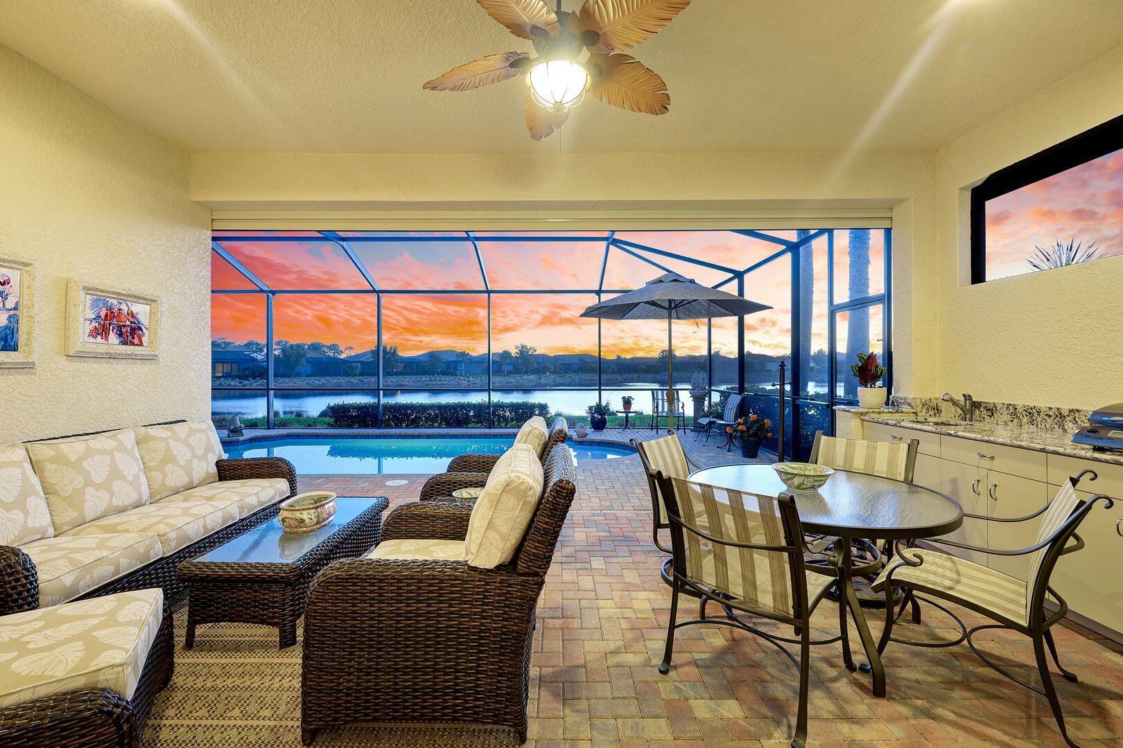 1433 Redona Way Naples, FL 34113 - Photo 4 of 50 a dining room with furniture a rug and a floor to ceiling window