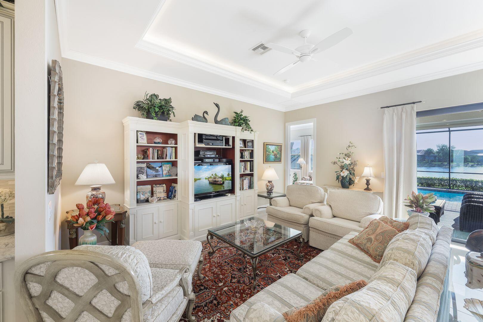 1433 Redona Way Naples, FL 34113 - Photo 5 of 50 a bedroom with furniture and a large window