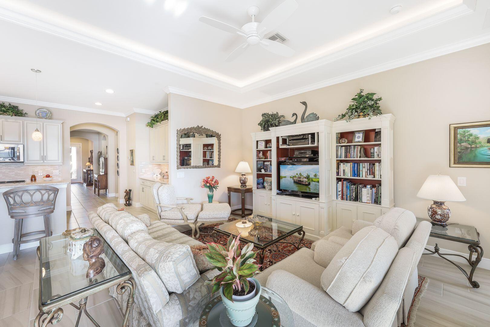 1433 Redona Way Naples, FL 34113 - Photo 8 of 50 a living room with furniture and a book shelf
