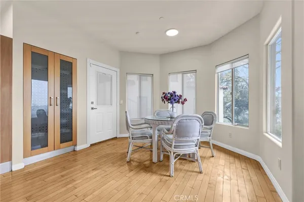 a dining room with furniture window and wooden floor