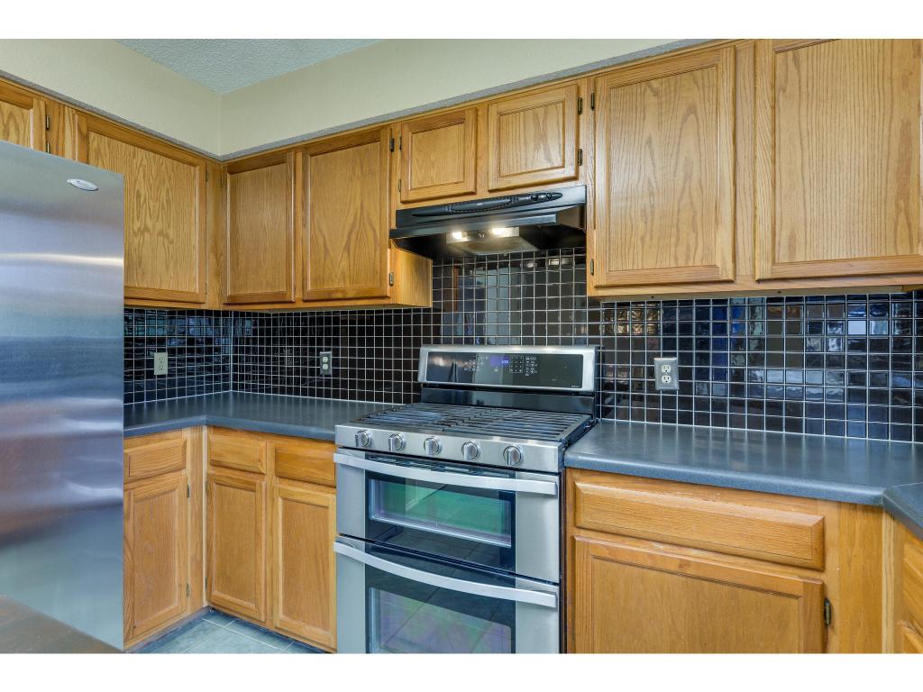 3912 Lemos Drive Austin, TX 78728 - Photo 12 of 40 a kitchen with granite countertop cabinets and black stainless steel appliances