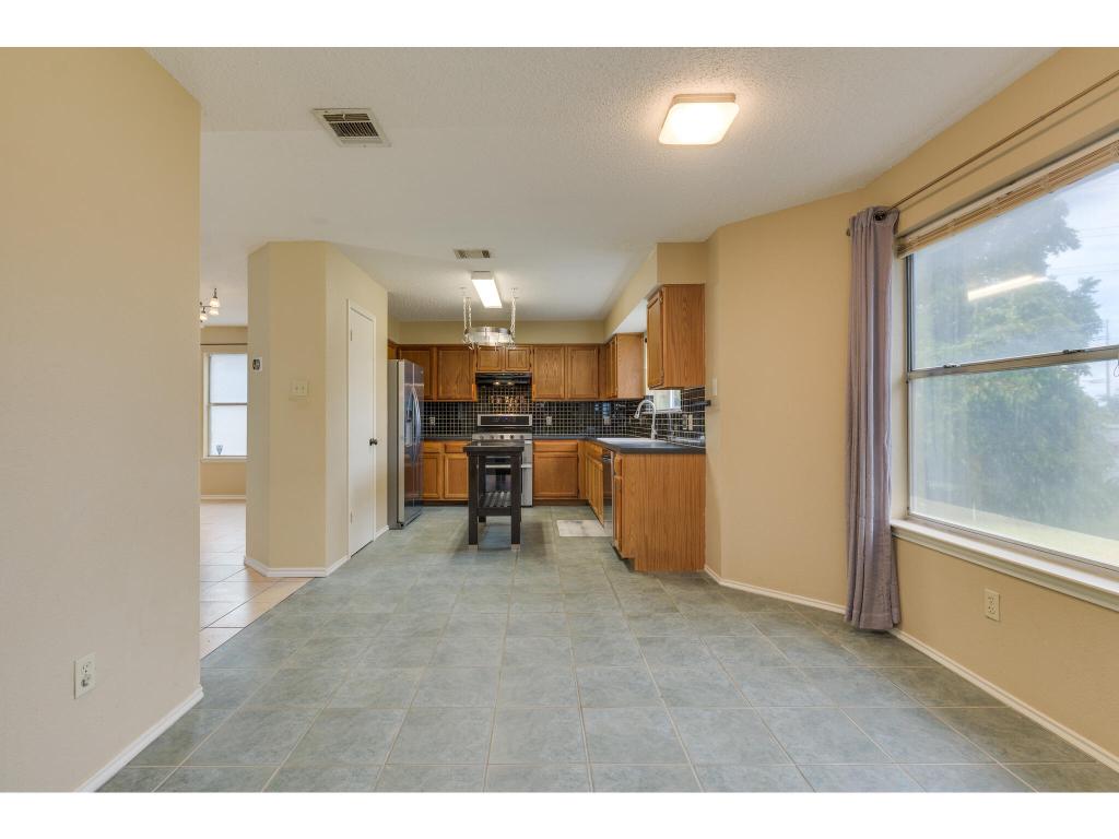 3912 Lemos Drive Austin, TX 78728 - Photo 14 of 40 a view of a kitchen with furniture and a kitchen