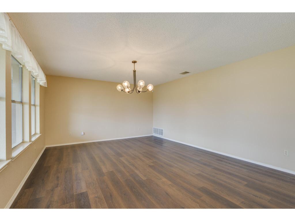 3912 Lemos Drive Austin, TX 78728 - Photo 15 of 40 a view of an empty room with wooden floor and a window