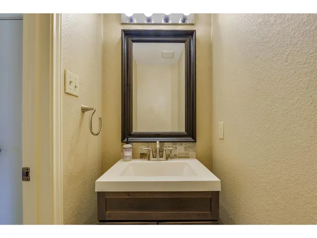 a bathroom with a sink a mirror and a shower