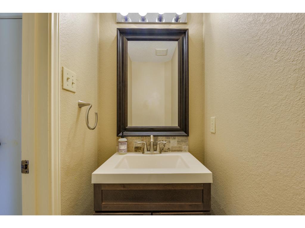 3912 Lemos Drive Austin, TX 78728 - Photo 19 of 40 a bathroom with a sink a mirror and a shower