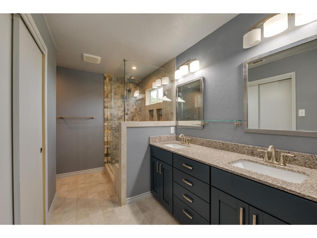 3912 Lemos Drive Austin, TX 78728 - Photo 28 of 40 a bathroom with a granite countertop sink mirror and a shower