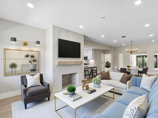 a living room with furniture a fireplace and a flat screen tv