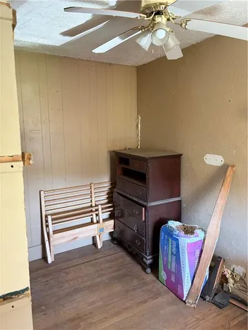 a room with wooden floor and furniture
