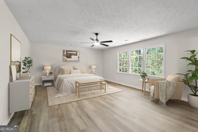 a spacious bedroom with a large bed and a window