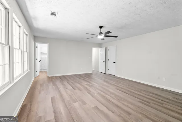 wooden floor in an empty room with a window