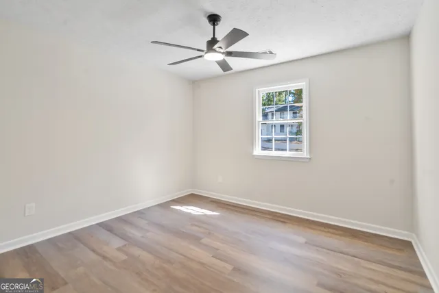 wooden floor in an empty room with a window
