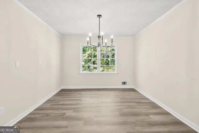 an empty room with windows and hallway