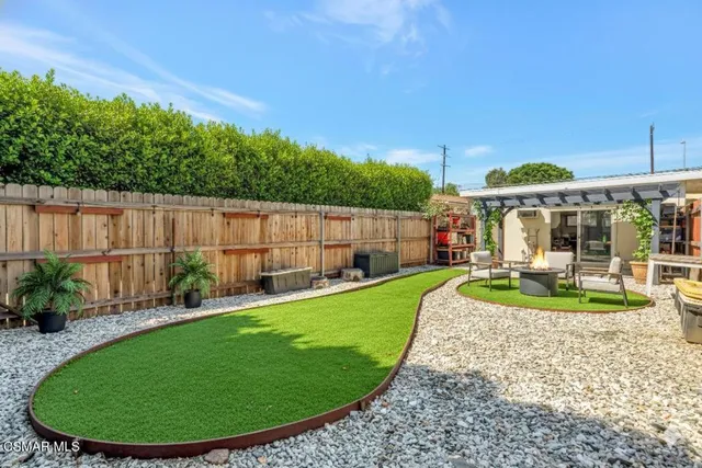 a view of a house with backyard sitting area and garden