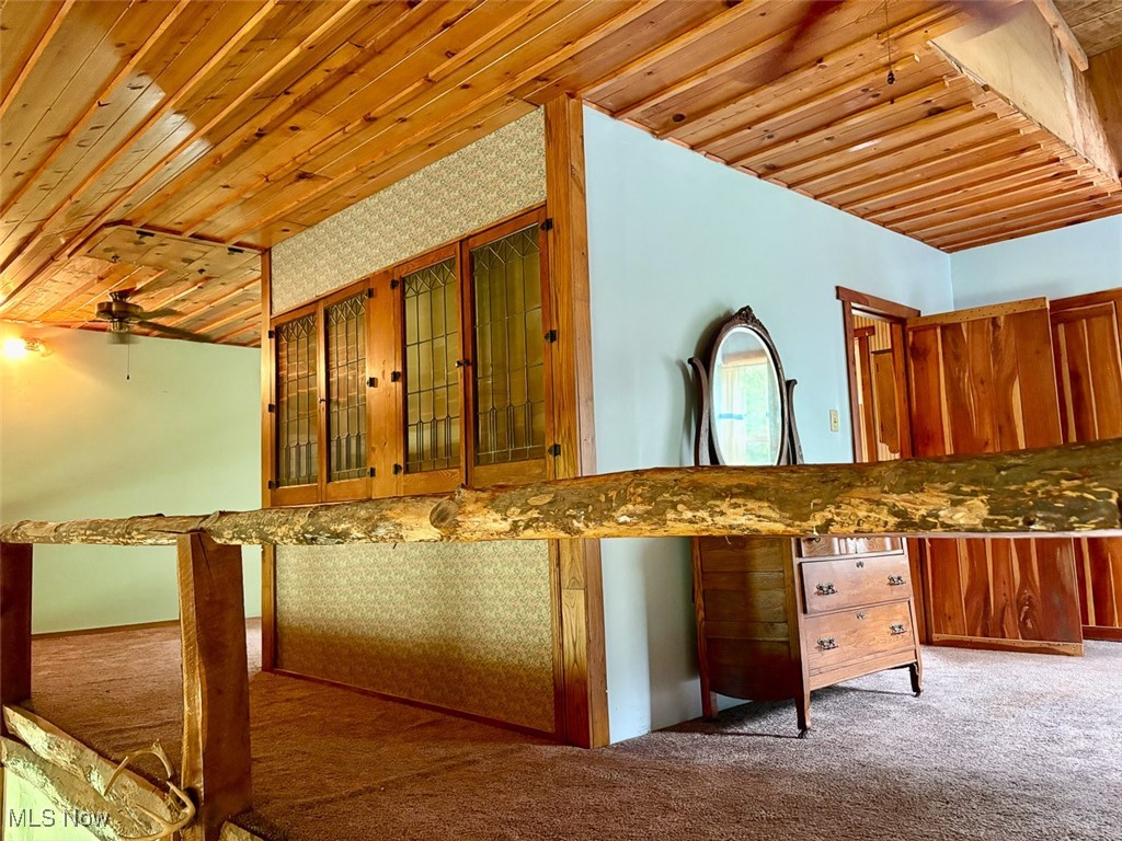 82755 Laughlin Road Tippecanoe, OH 44699 - Photo 32 of 35 Loft featuring wooden ceiling, carpet floors, glass insert cabinets, and brown cabinetry