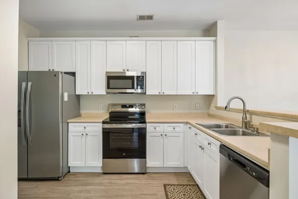 a kitchen with a sink stove and refrigerator