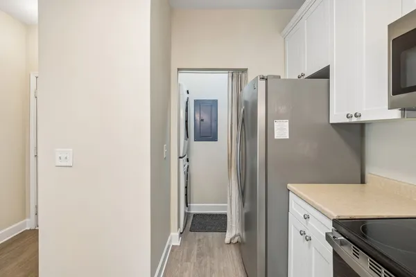 a view of a kitchen with a sink and a refrigerator