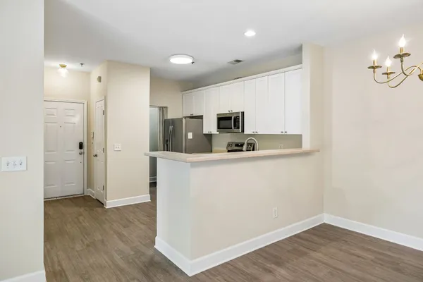 a kitchen with stainless steel appliances a refrigerator sink and microwave