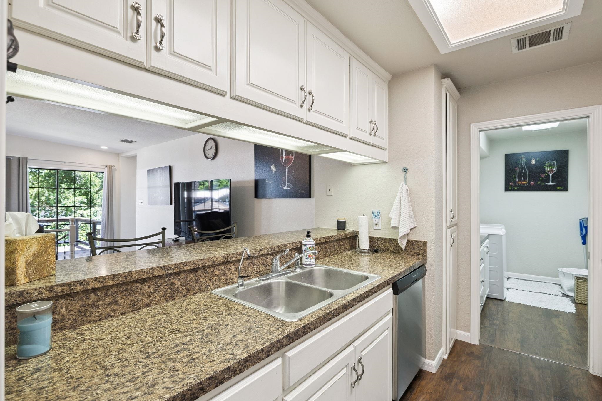 1435 East Zipp Road New Braunfels, TX 78130 - Photo 33 of 43 a kitchen with stainless steel appliances granite countertop a sink stove and cabinets