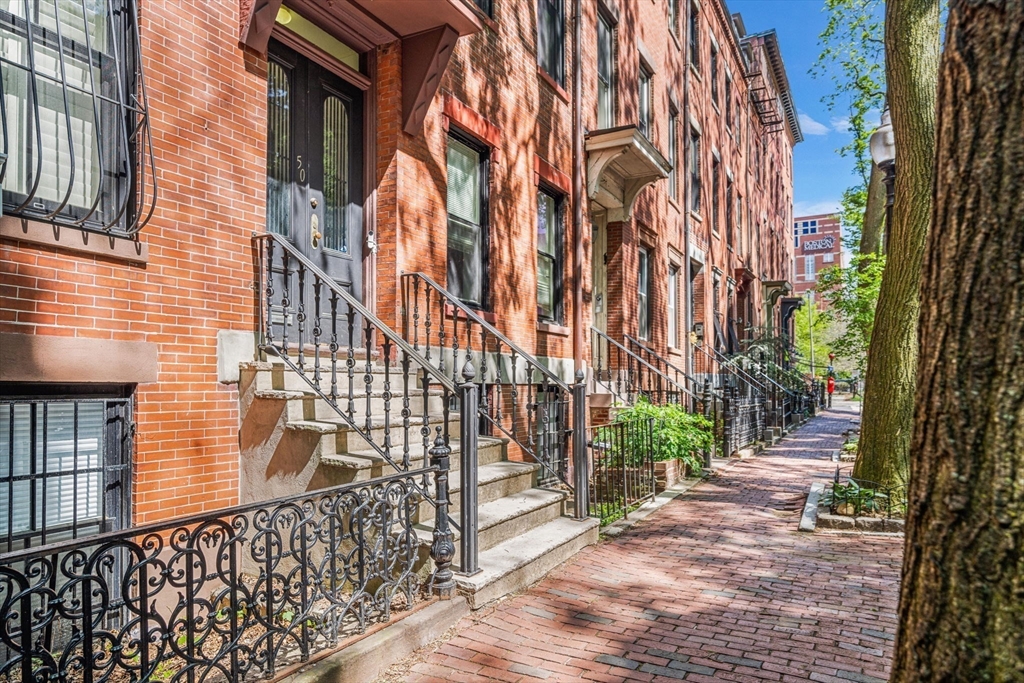 a view of a brick building with many windows
