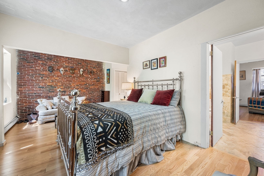 50 East Springfield Street, Unit 1 Boston, MA 02118 - Photo 13 of 23 a bedroom with a bed and wooden floor