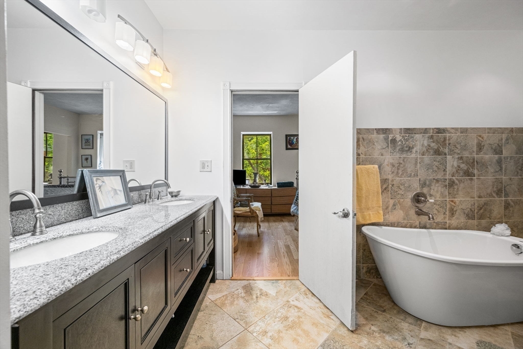 50 East Springfield Street, Unit 1 Boston, MA 02118 - Photo 14 of 23 a spacious bathroom with a granite countertop tub sink and mirror