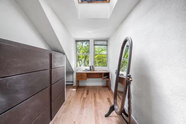 a view of a room with wooden floor and furniture