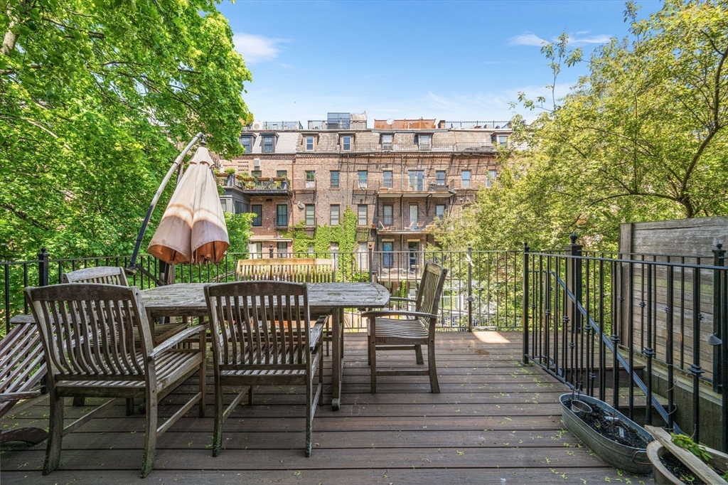 50 East Springfield Street, Unit 1 Boston, MA 02118 - Photo 19 of 23 a view of a roof deck with table and chairs and wooden floor