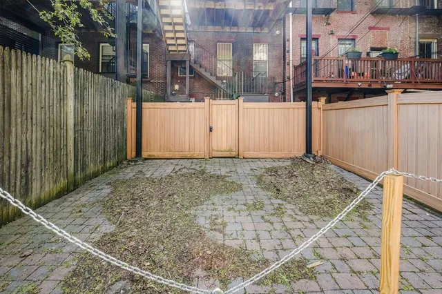 a view of a house with a wooden fence