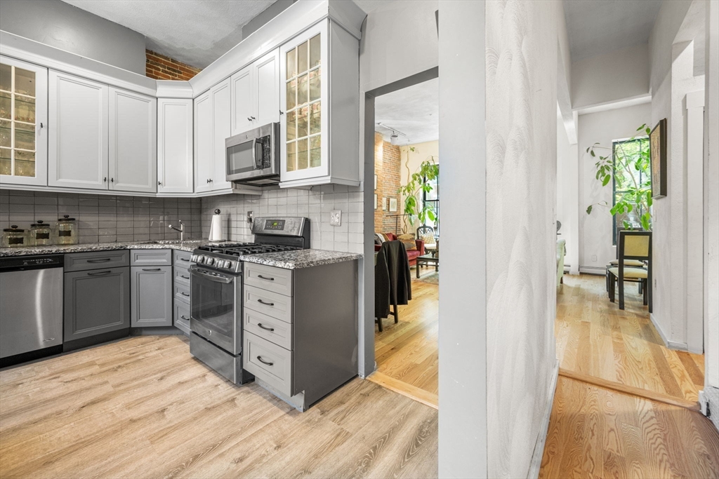50 East Springfield Street, Unit 1 Boston, MA 02118 - Photo 5 of 23 a kitchen with stainless steel appliances granite countertop a stove a sink and a refrigerator