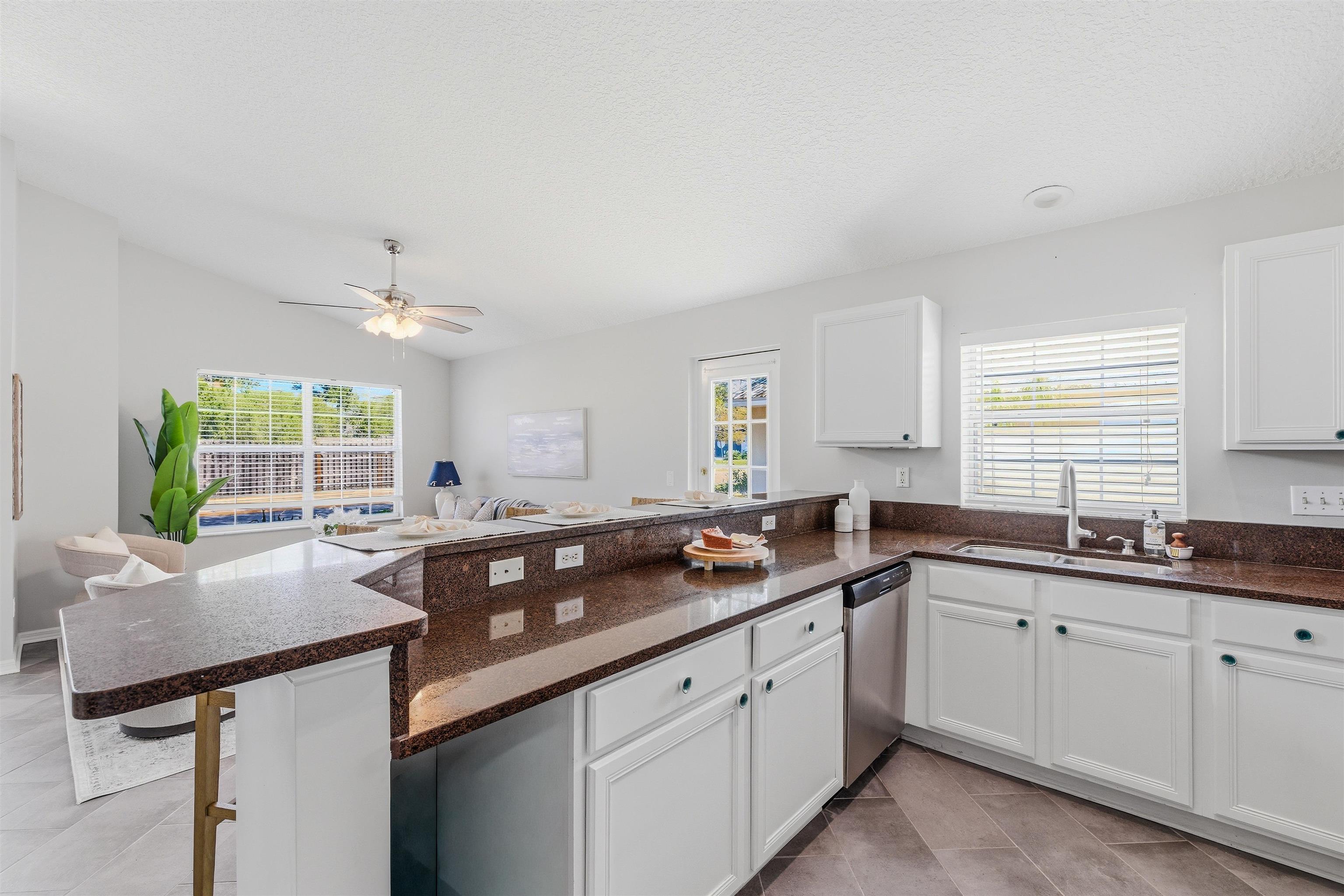 207 11th Street St. Augustine, FL 32080 - Photo 14 of 28 a kitchen with a sink and cabinets