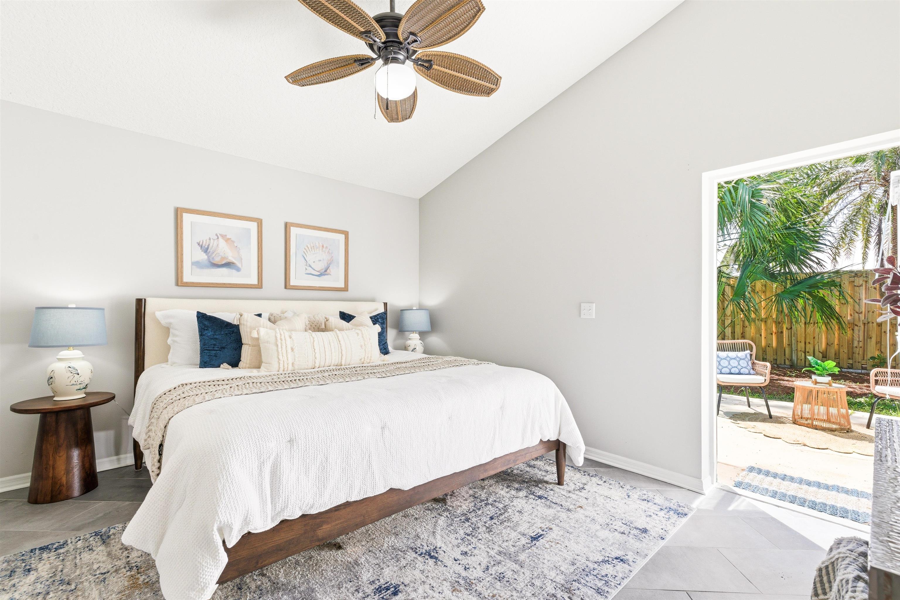 207 11th Street St. Augustine, FL 32080 - Photo 19 of 28 a bedroom with a large bed and a chandelier